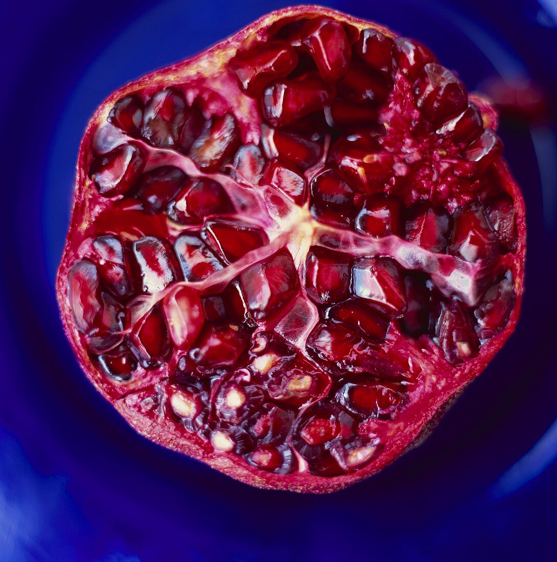 Half a pomegranate against blue background