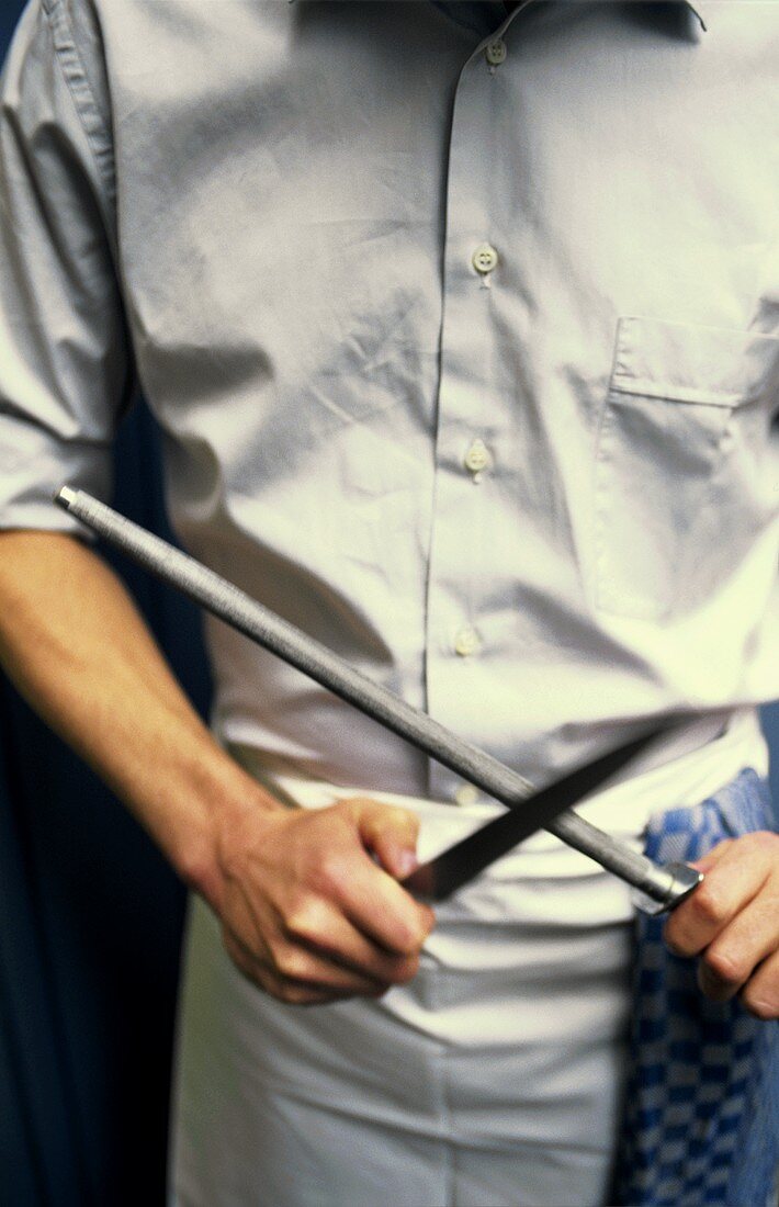 Chef sharpening a knife