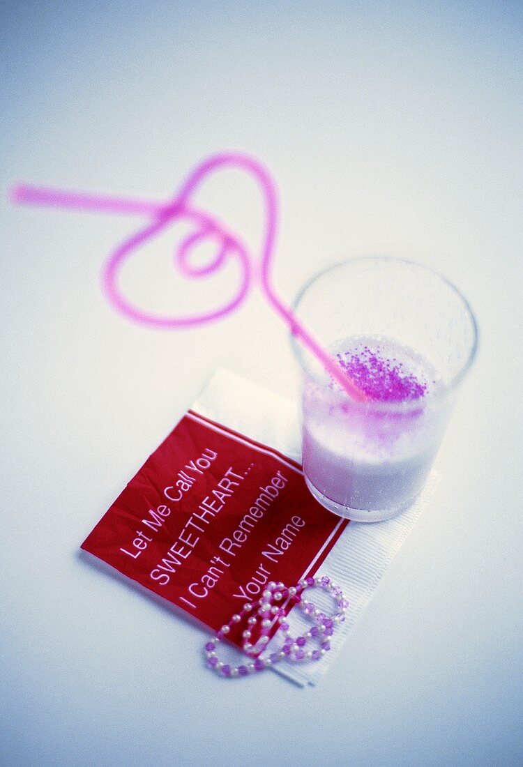 Strawberry shake with heart-shaped straw