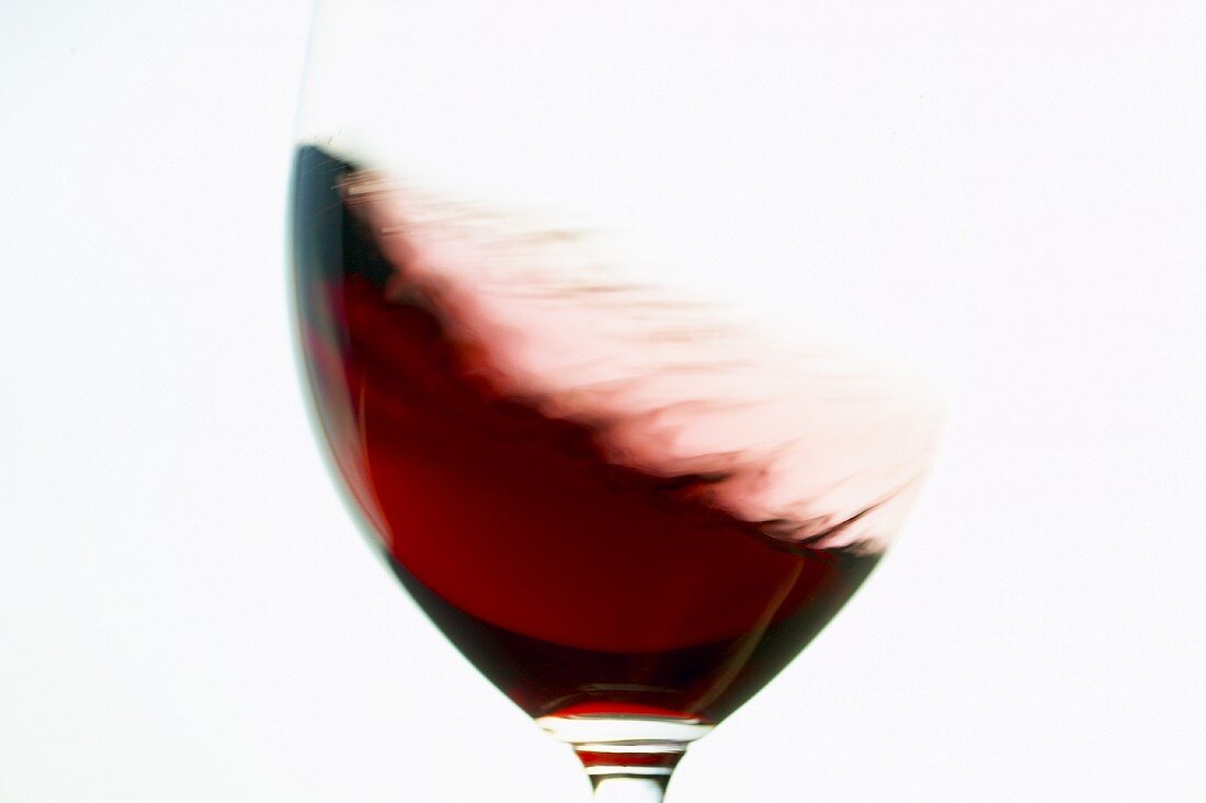 Red wine being swirled round in glass