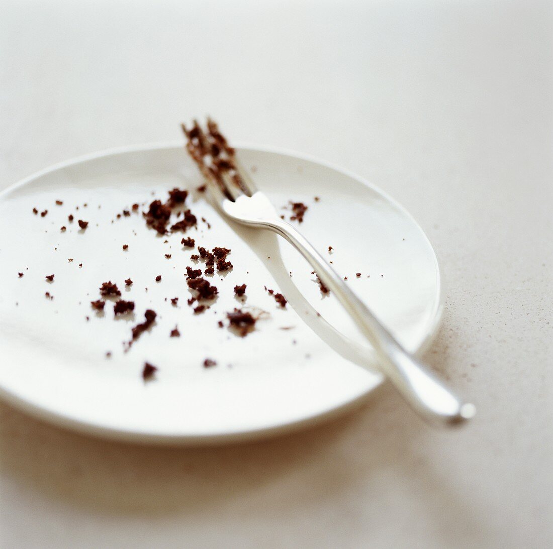 Plate with fork and cake crumbs