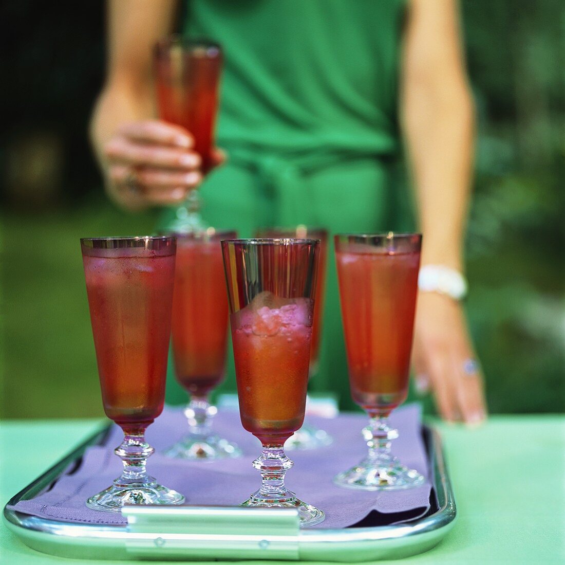 Drinks with strawberries on tray in open air