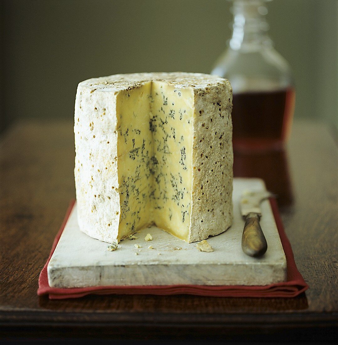 Stilton cheese with knife and port wine