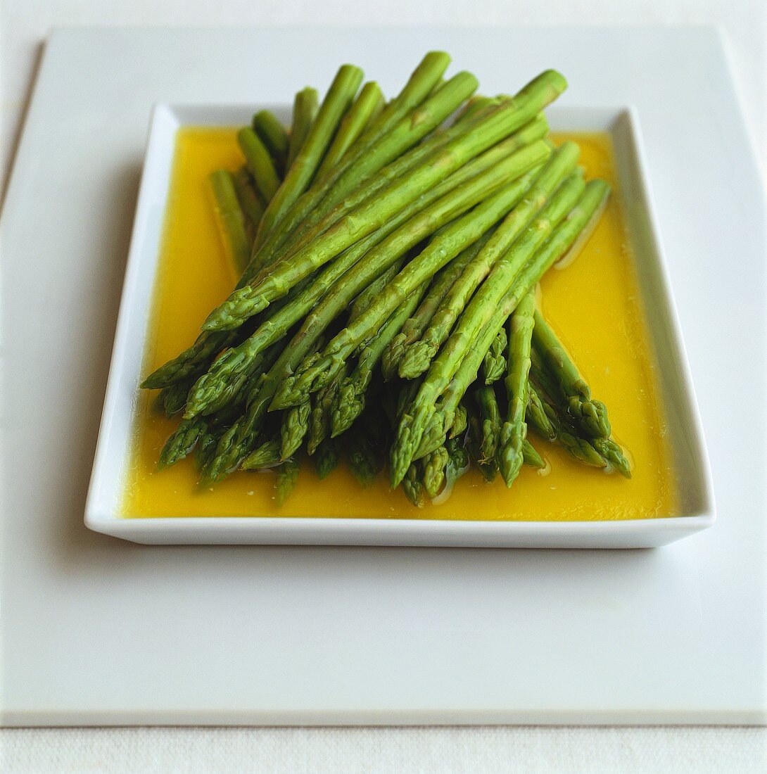 Green asparagus in melted butter