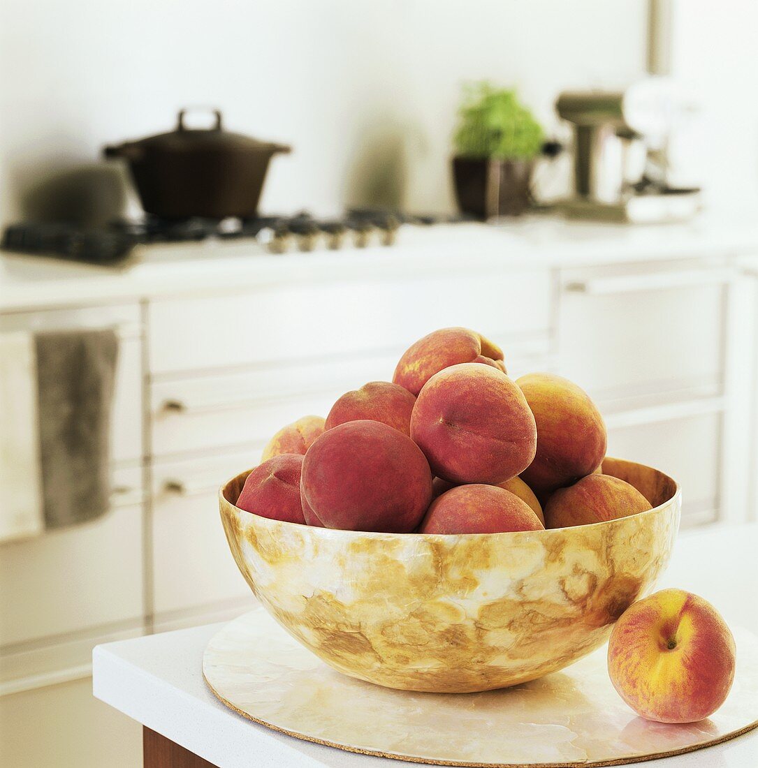 Peaches in a bowl in a kitchen