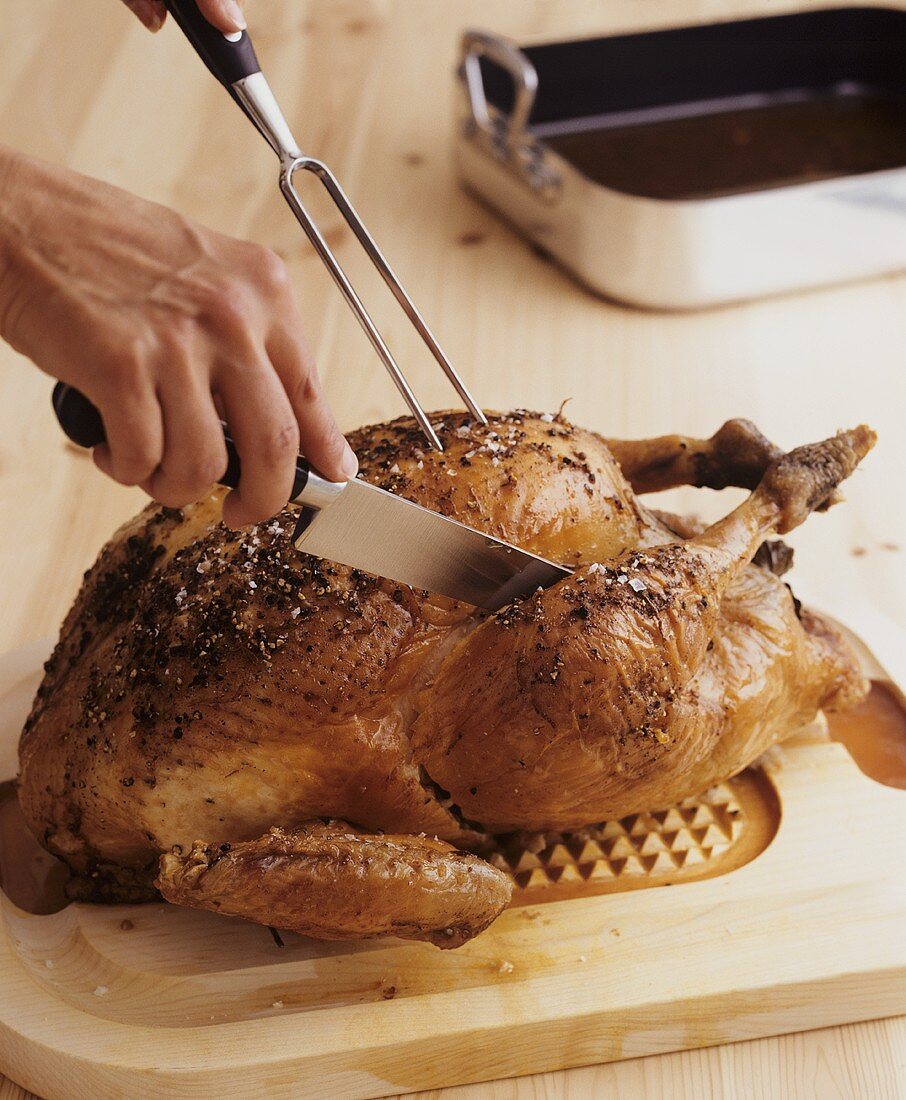 Carving roast turkey with carving cutlery