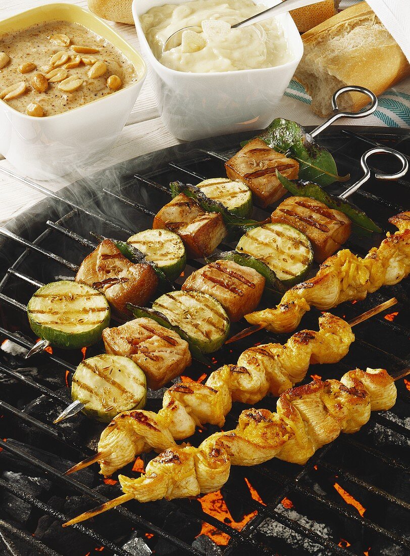Chicken saté and fish kebabs on barbecue