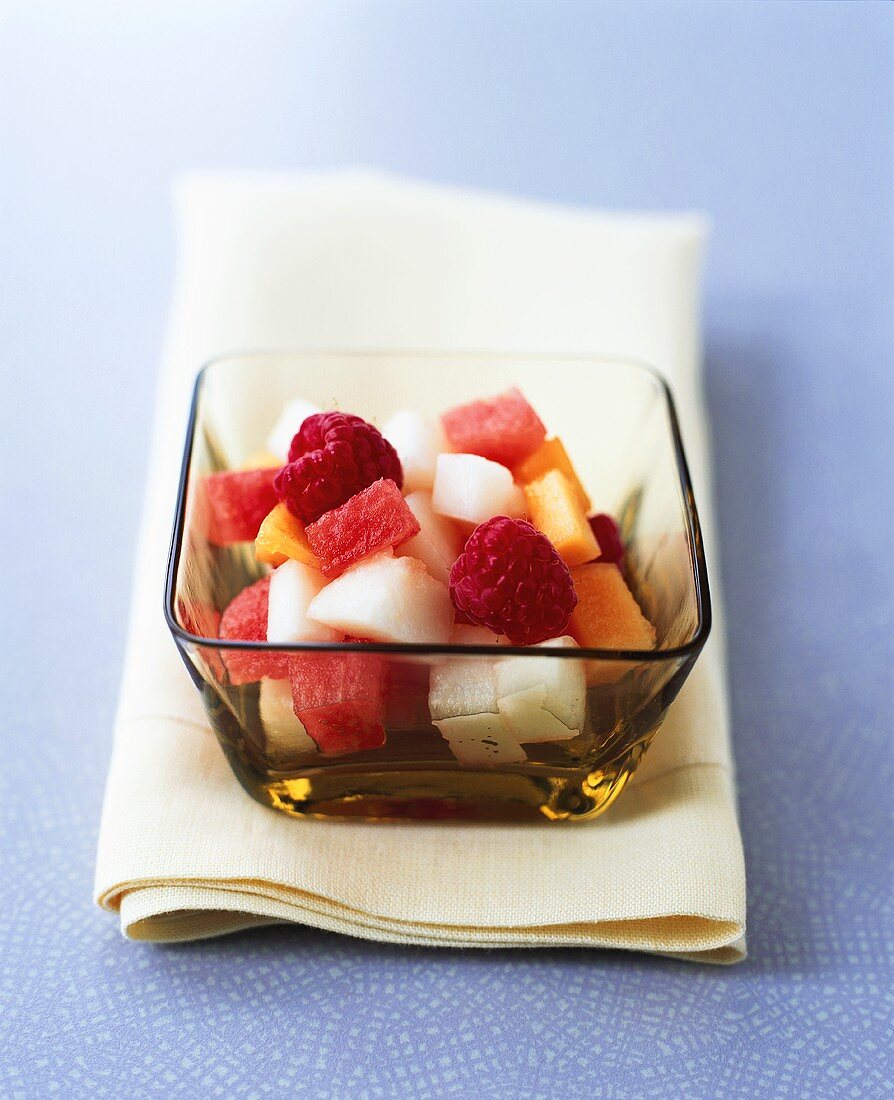 Chilled vodka with melon and raspberry salad