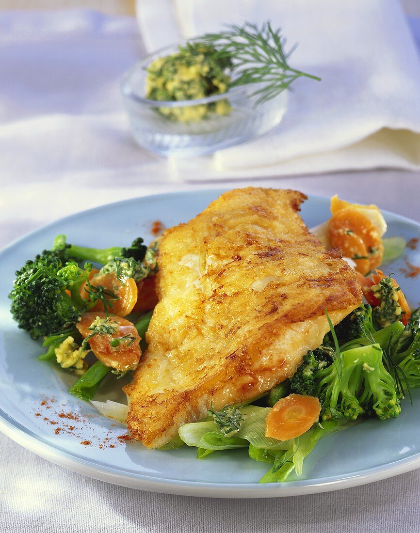 Fried fish with vegetables and herbs