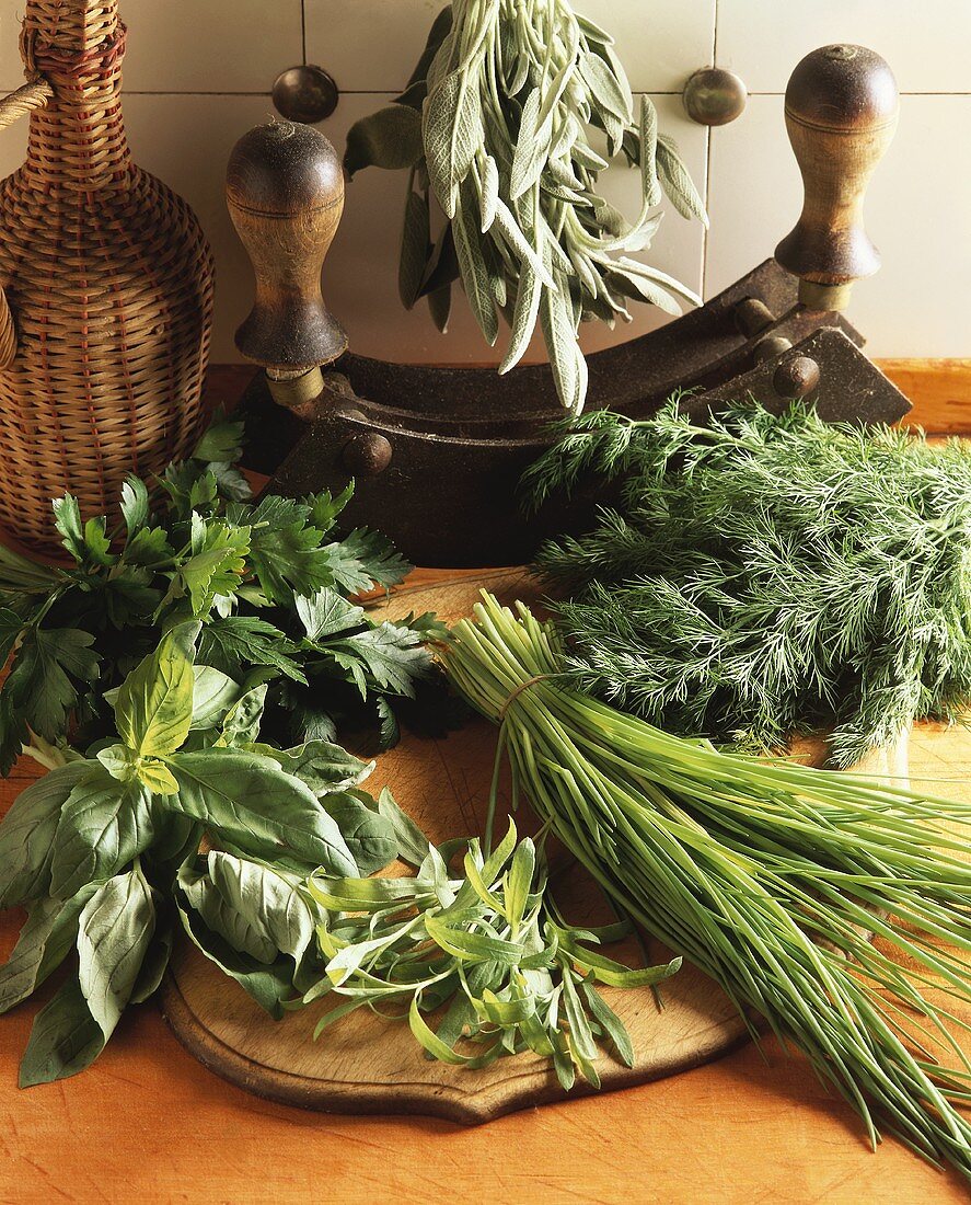 Still life with fresh herbs and mezzaluna