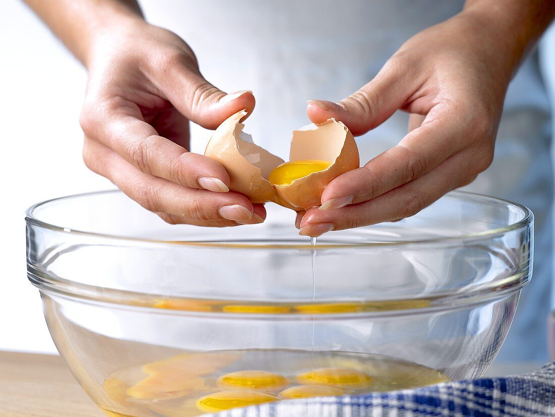 Breaking eggs into a bowl