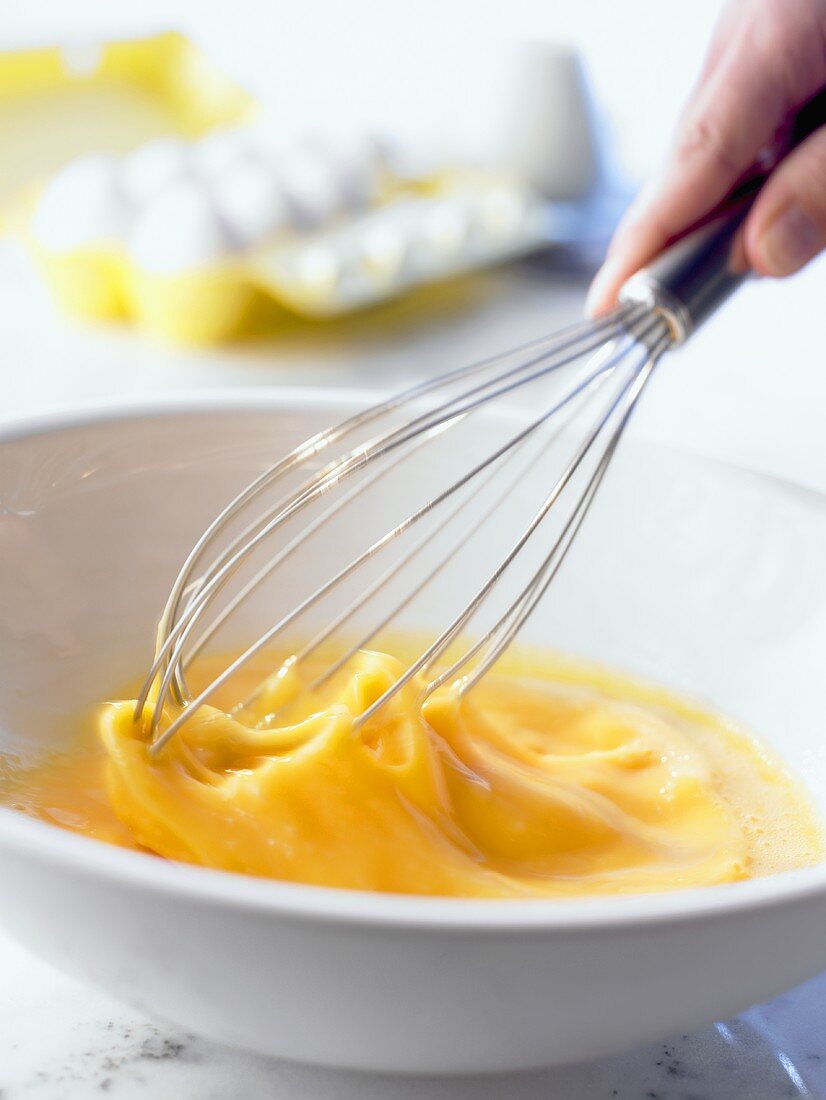 Beating eggs with egg whisk