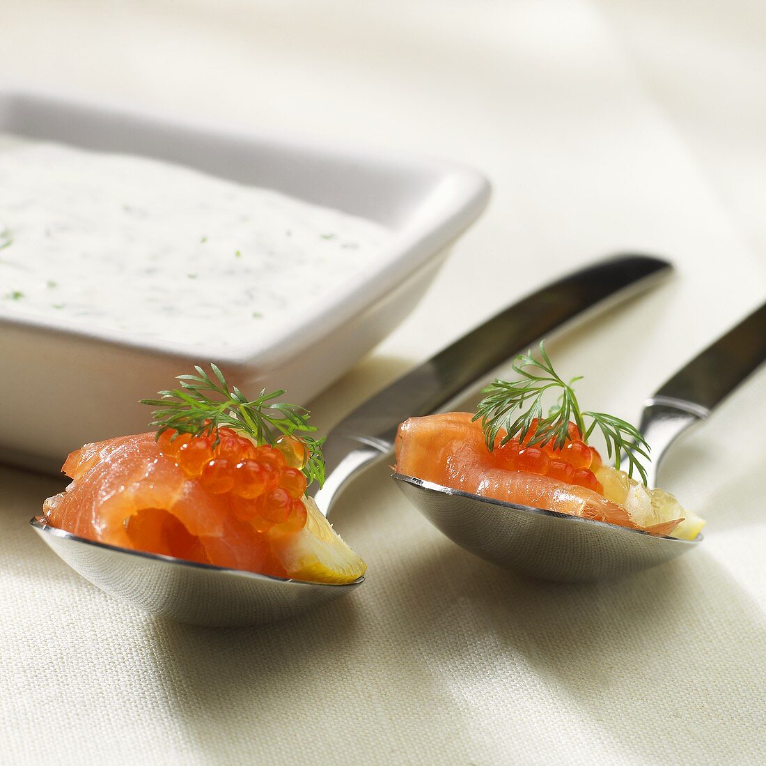 Party snacks: salmon with salmon caviare on spoons