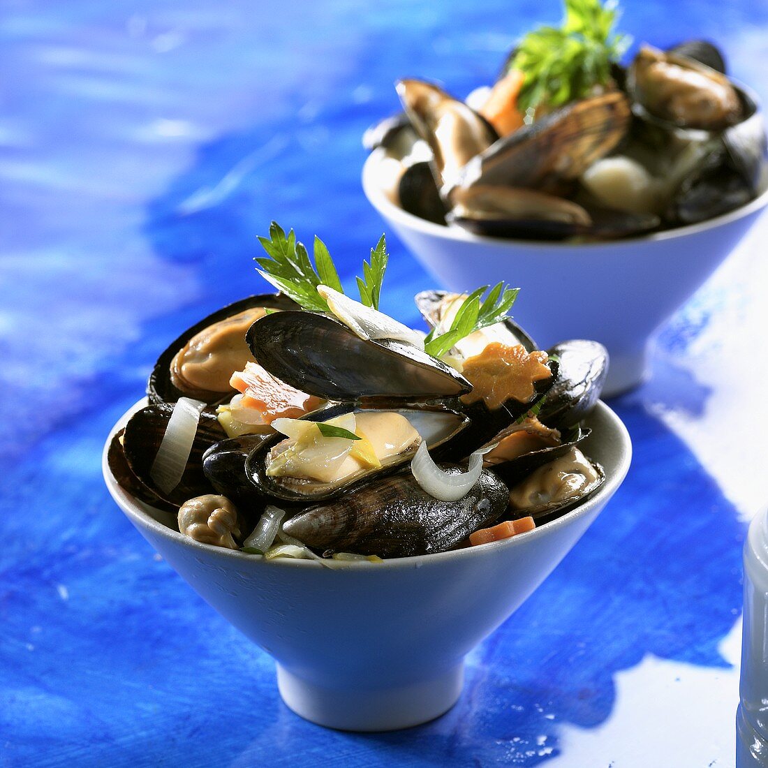 Small bowl of cooked mussels and vegetables