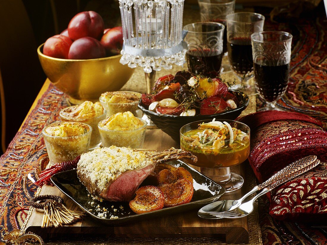 Rack of lamb and accompaniments on Middle Eastern table