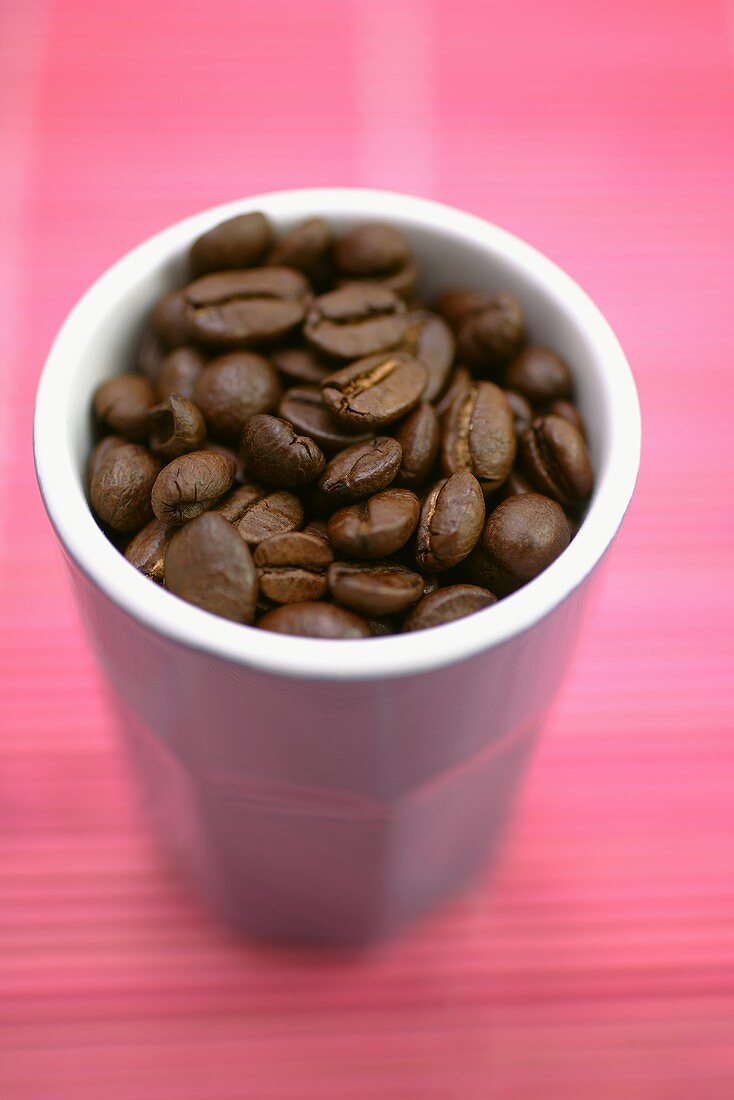 Coffee beans in beaker