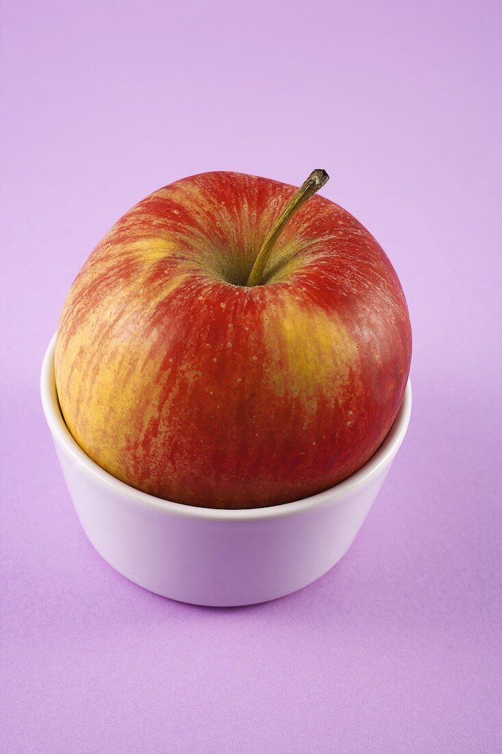 Apple in a small ceramic bowl