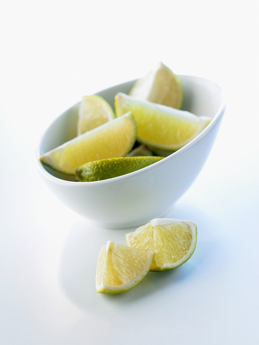 Pieces of lime in and in front of a bowl