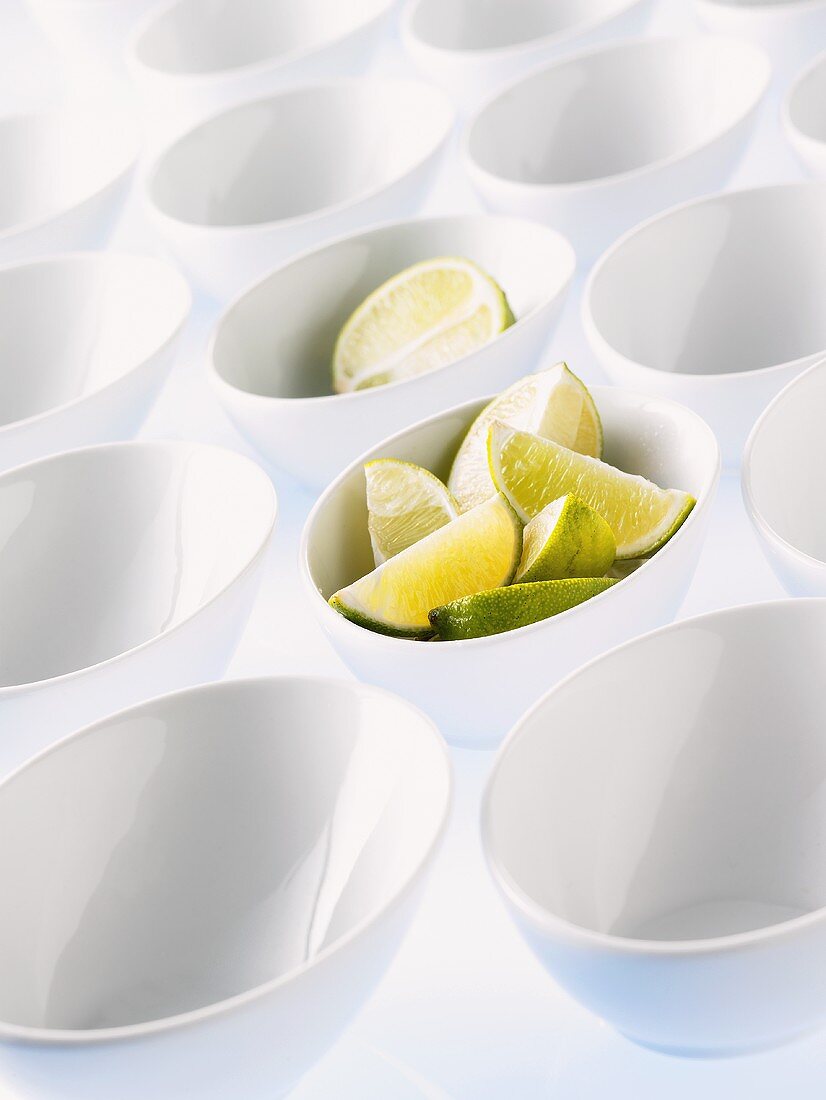 Lots of white bowls, two full of lime pieces