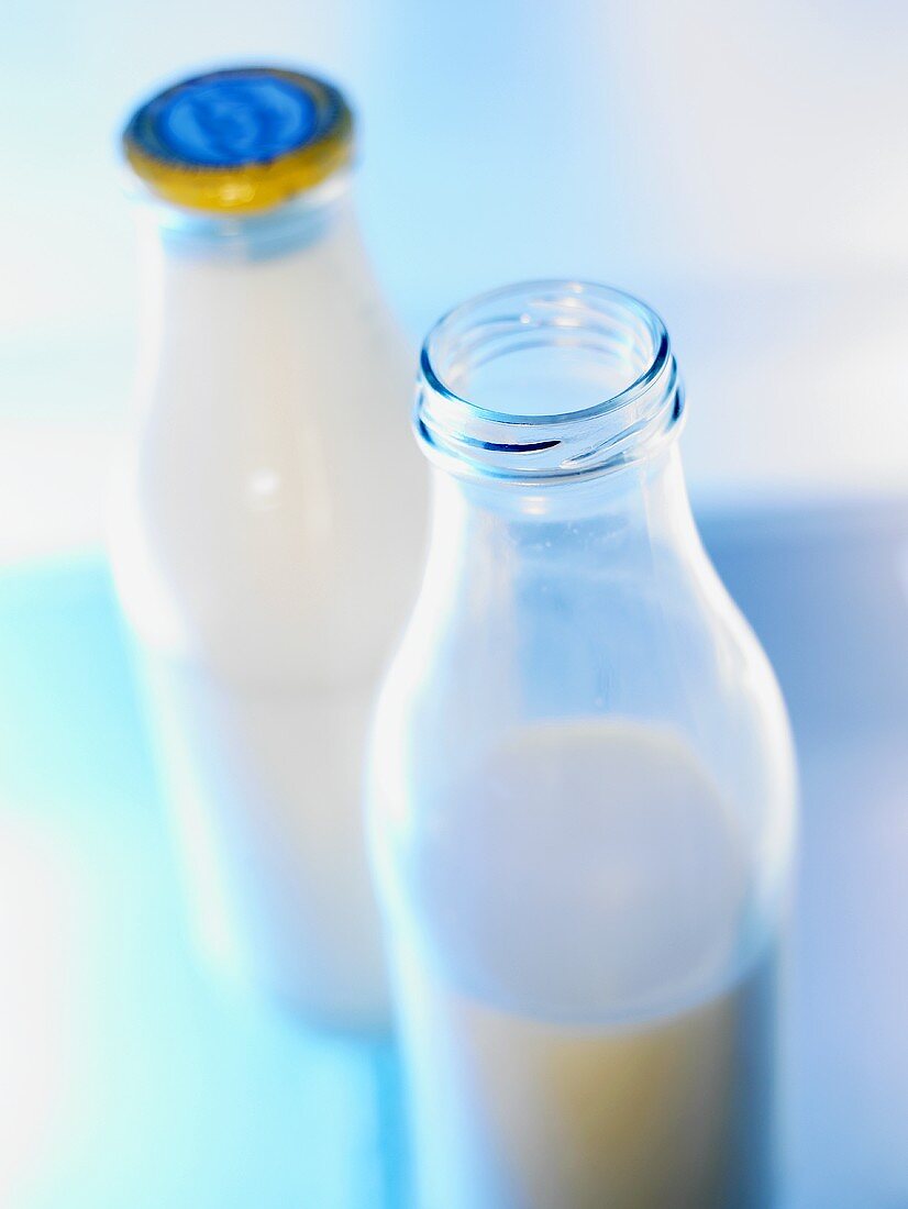 Two milk bottles, one opened