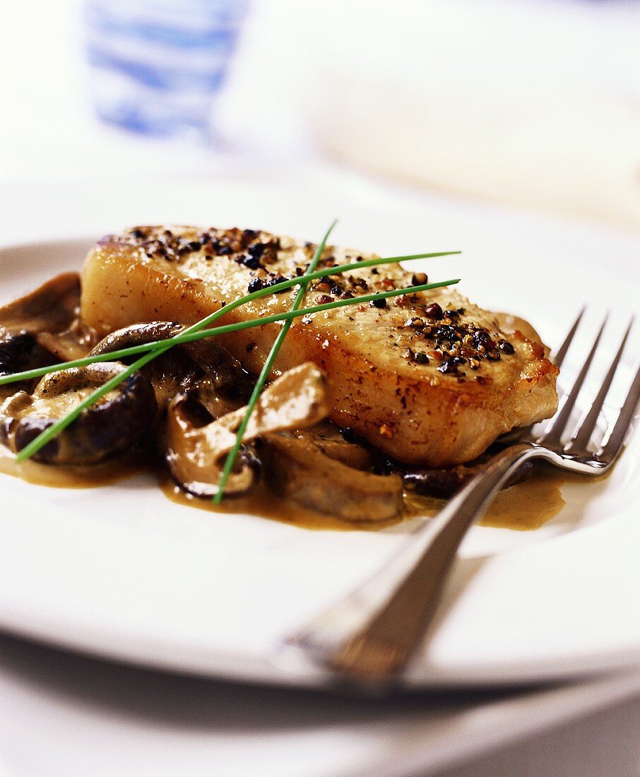 Pork steak with pepper and mushroom sauce