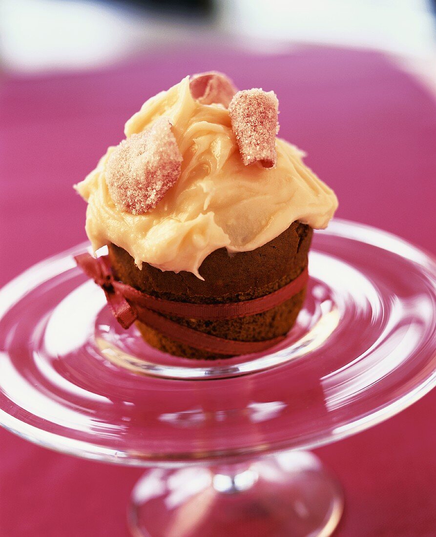 Chocolate muffin with cream and candied rose petals