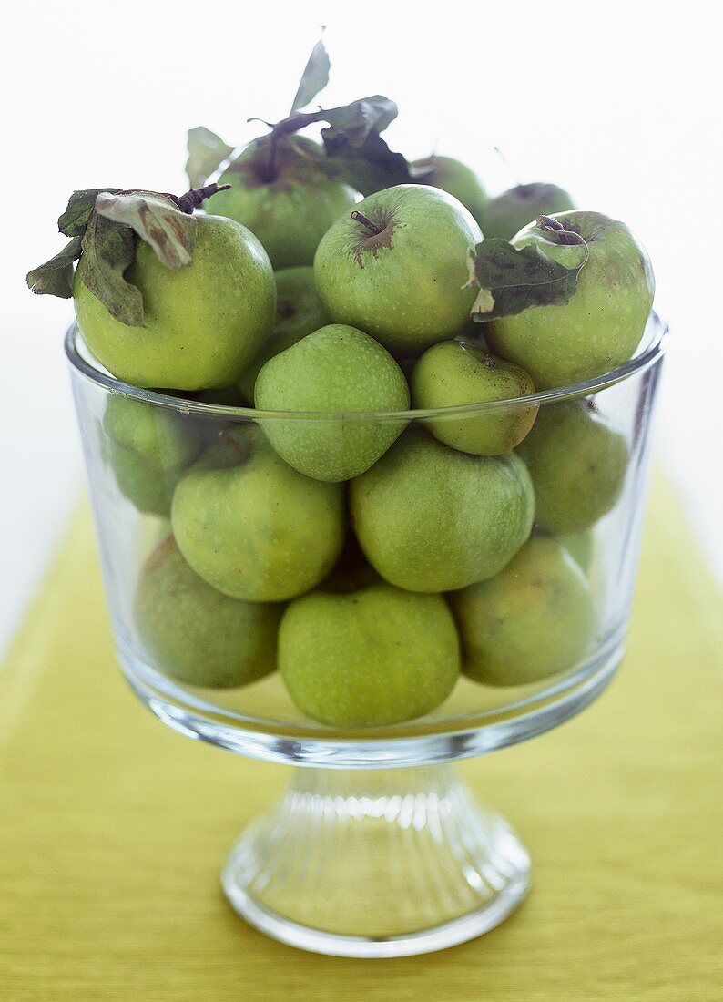 Green apples in glass bowl