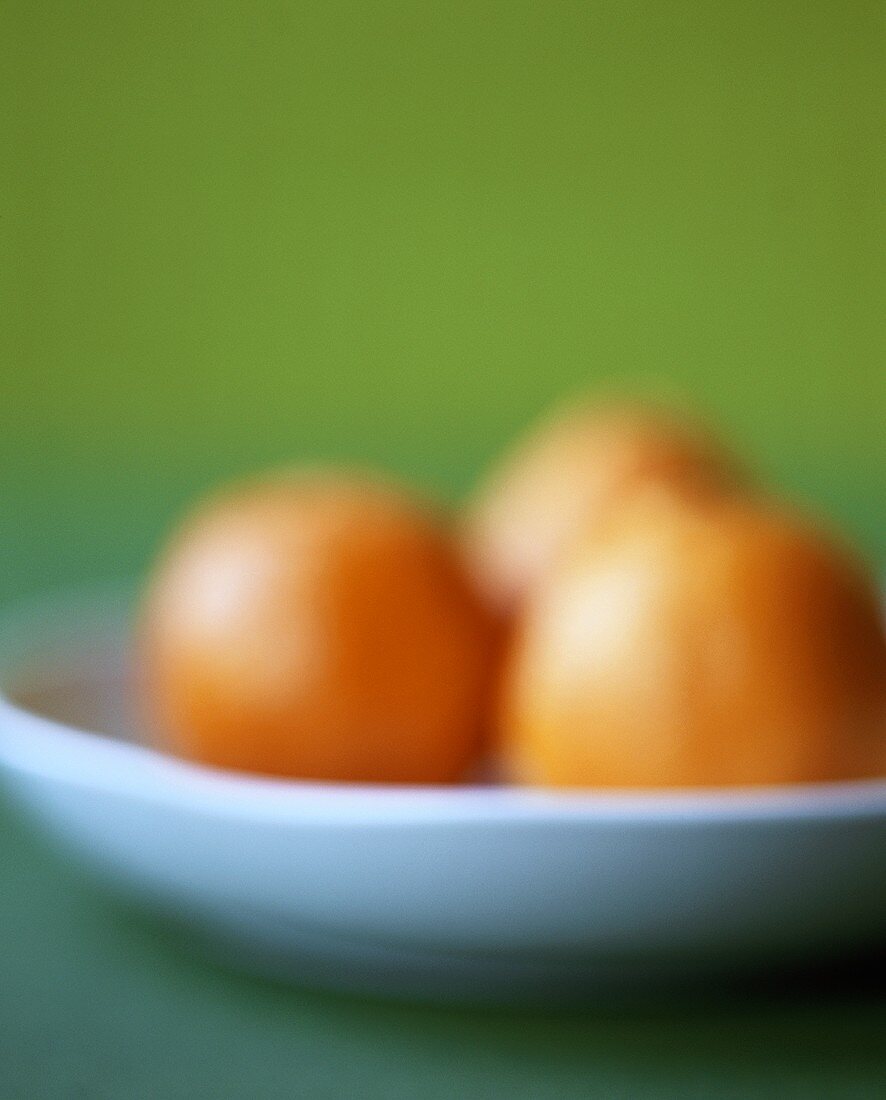 Three oranges in bowl