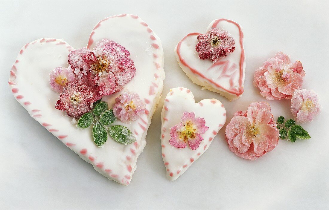 Three heart-shaped cakes with sugared roses