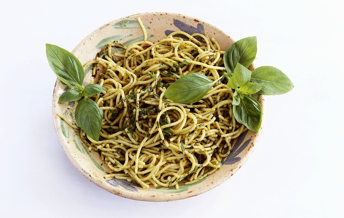 A plate of spaghetti with basil pesto