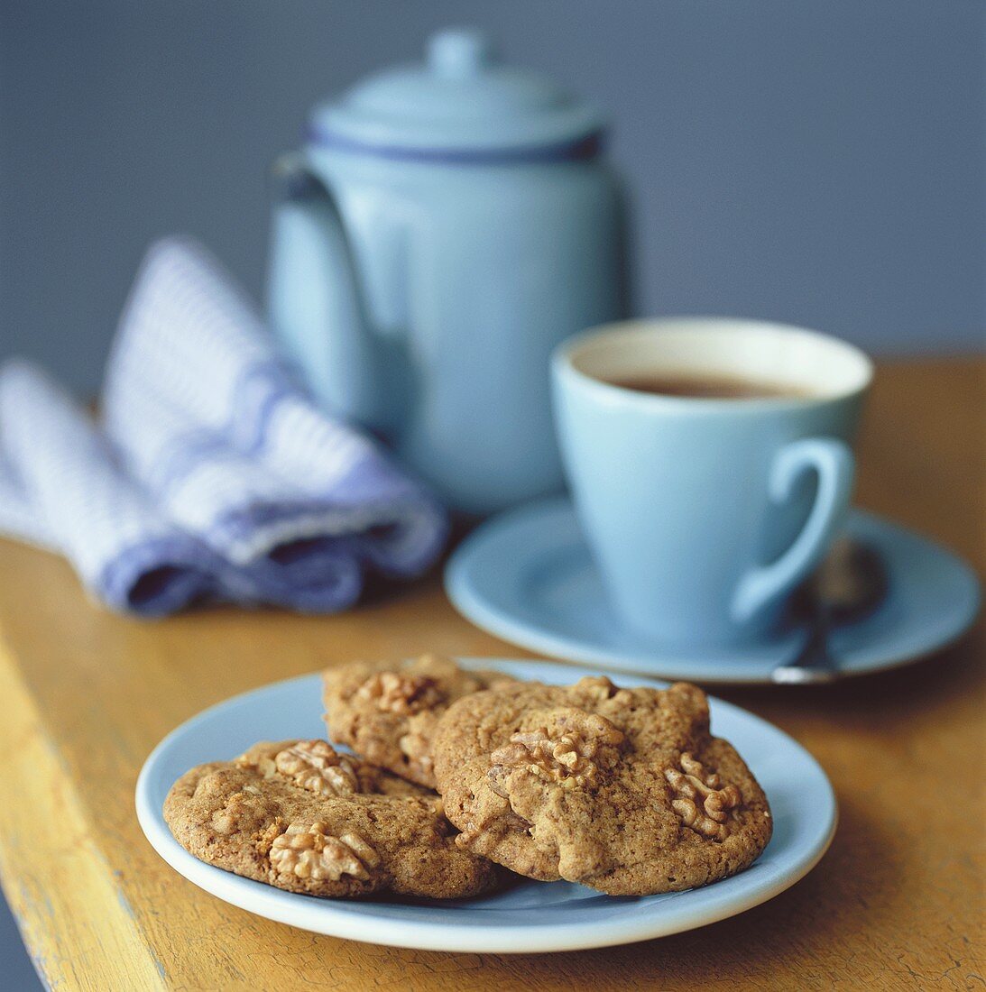 Walnut biscuits, a cup of tea and teapot