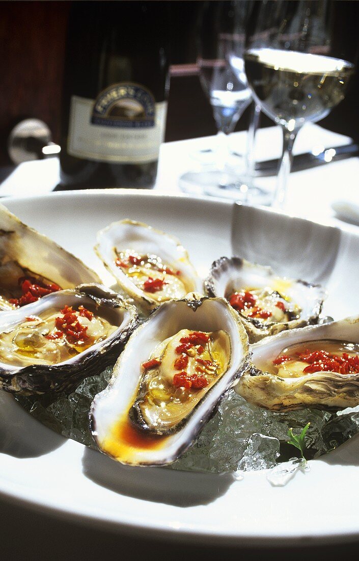 Oysters with chili and olive oil on ice