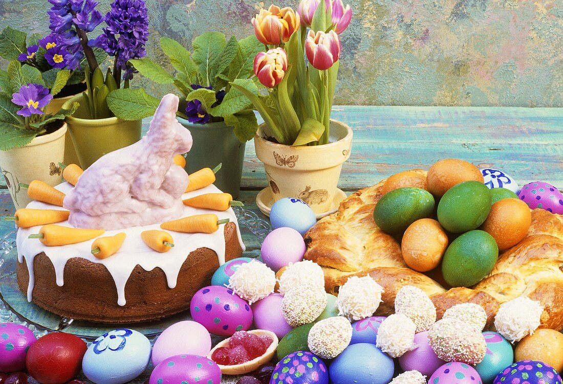 Easter table with carrot cake, bread wreath & Easter eggs