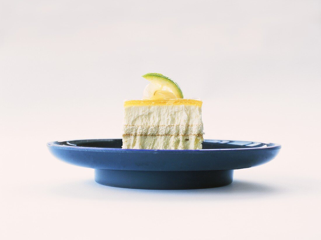 A piece of lemon ice cream cake on blue plate