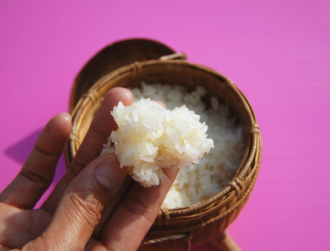 Hand with cooked sticky rice