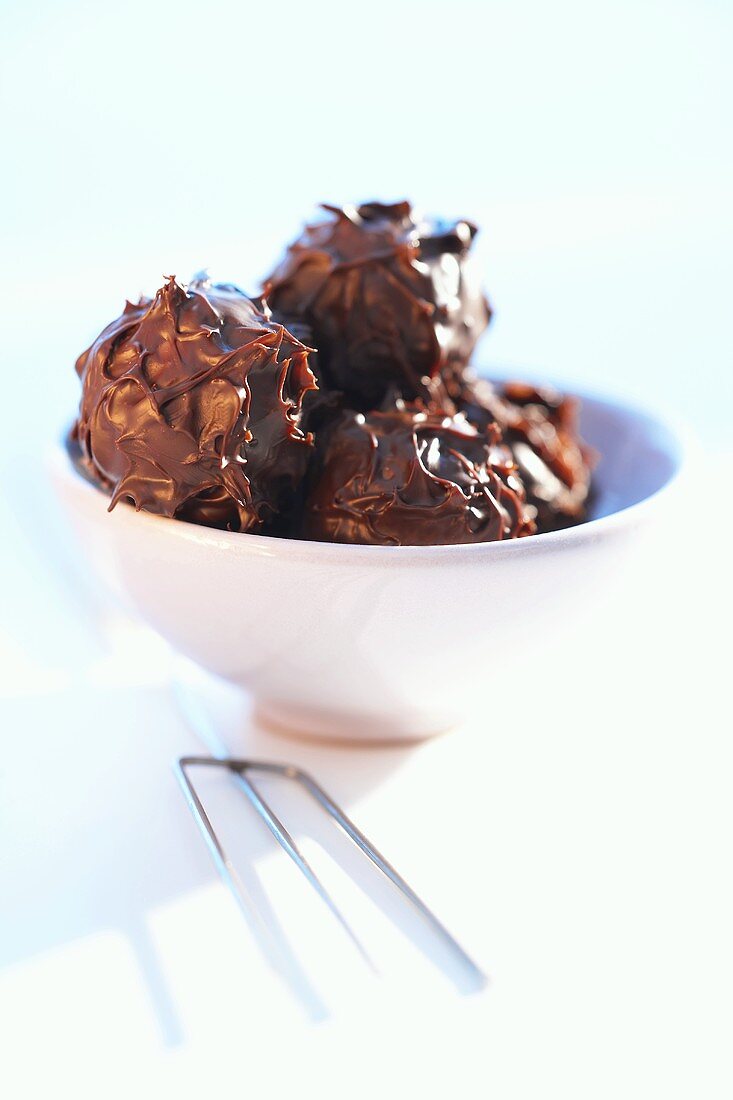 Several chocolate truffles in a bowl