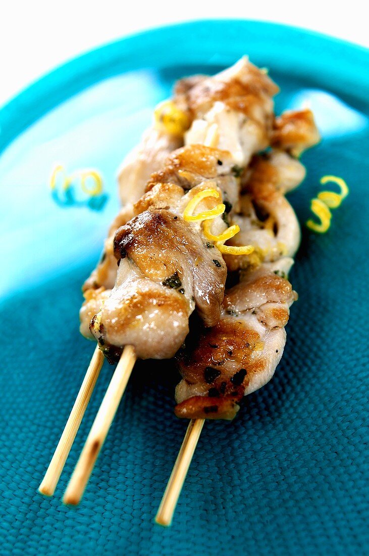 Three meat kebabs with lemon zest