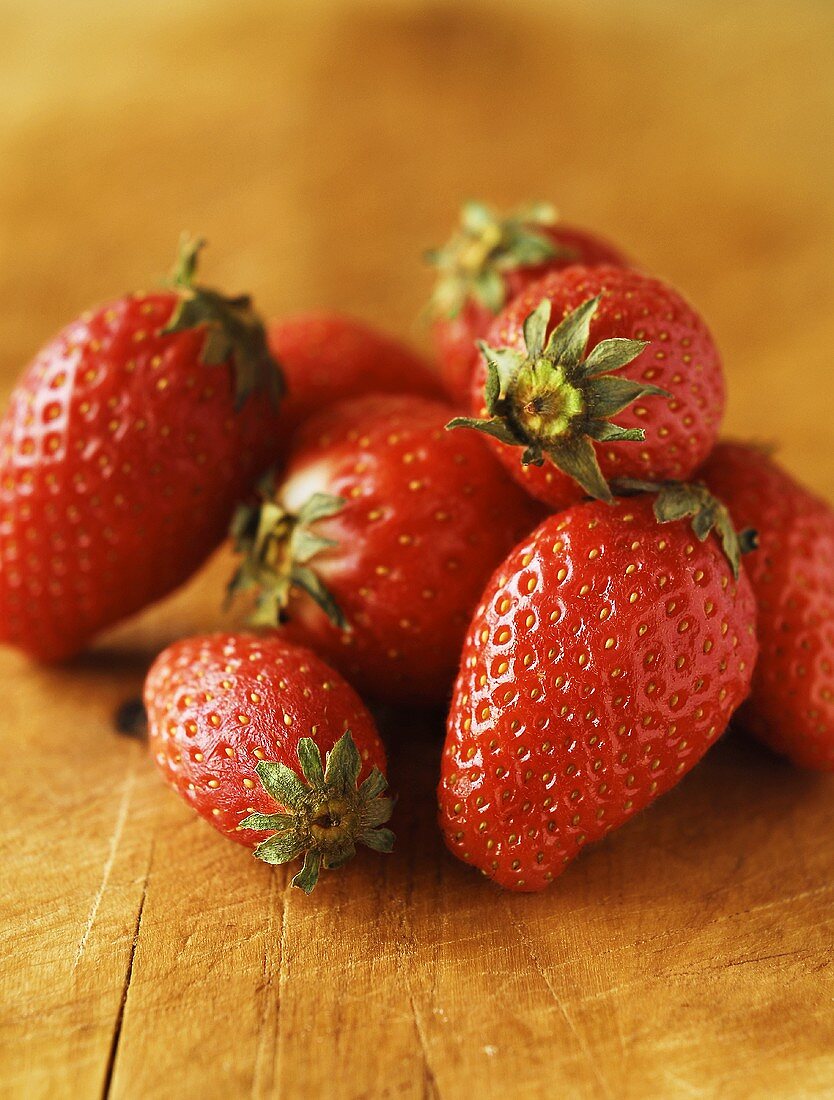 Ein Haufen frischer Erdbeeren auf Holzuntergrund