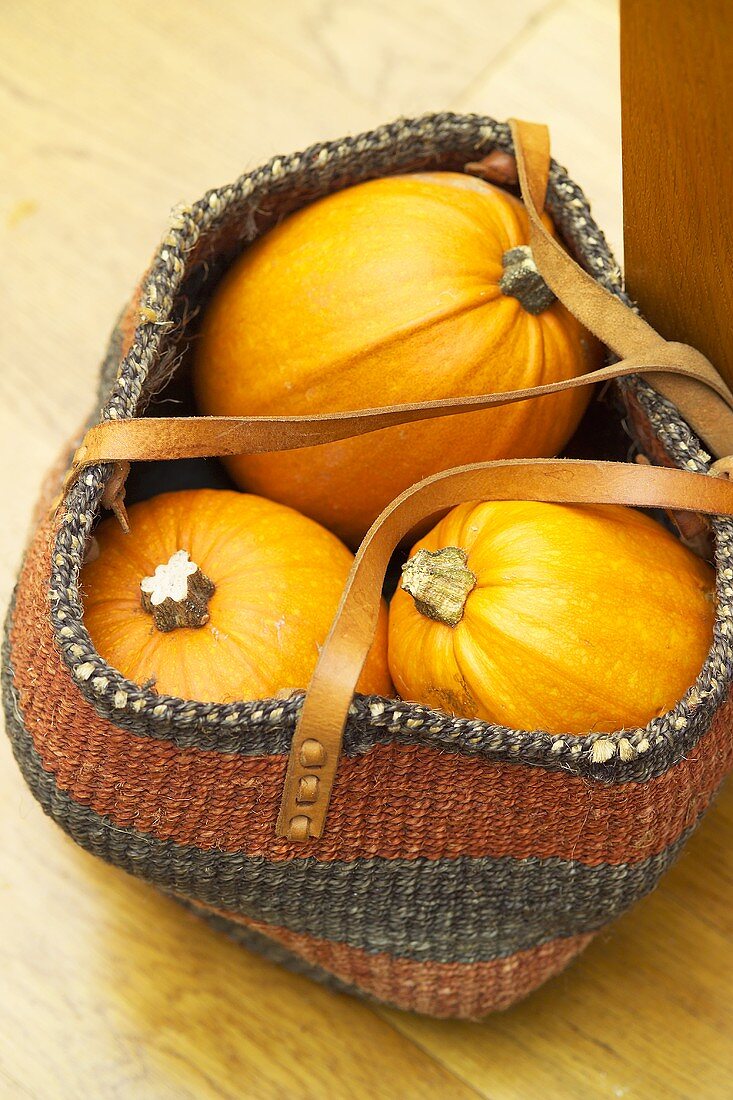 Three pumpkins in a shopping bag