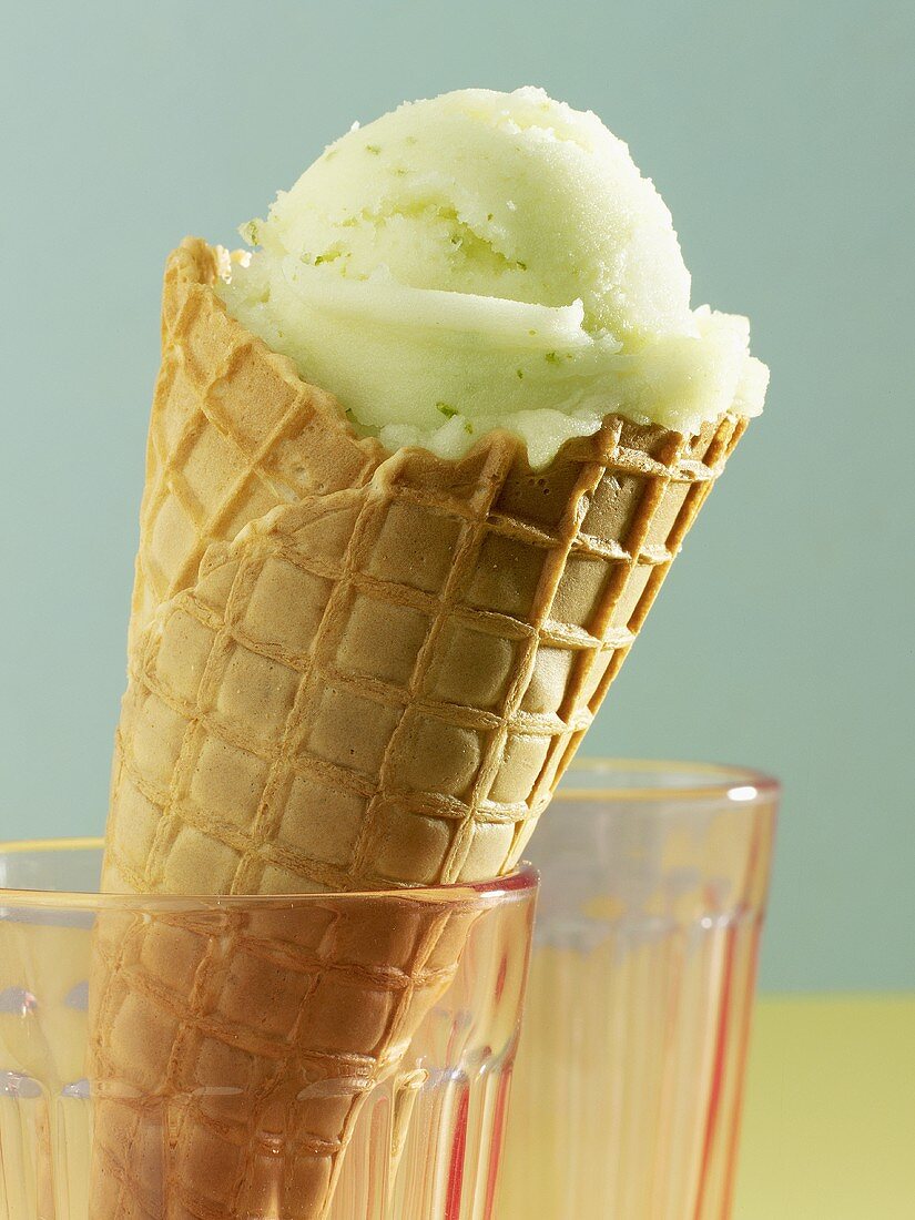 A scoop of basil and lime sorbet in a cone