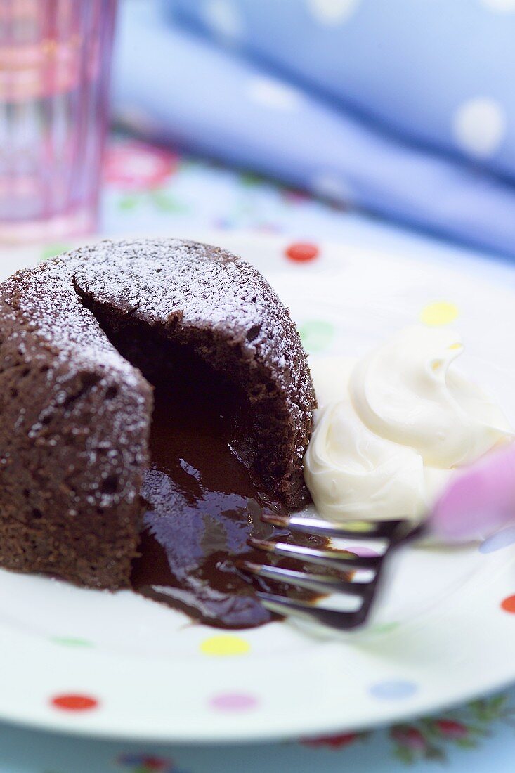Filled chocolate pudding with icing sugar and cream