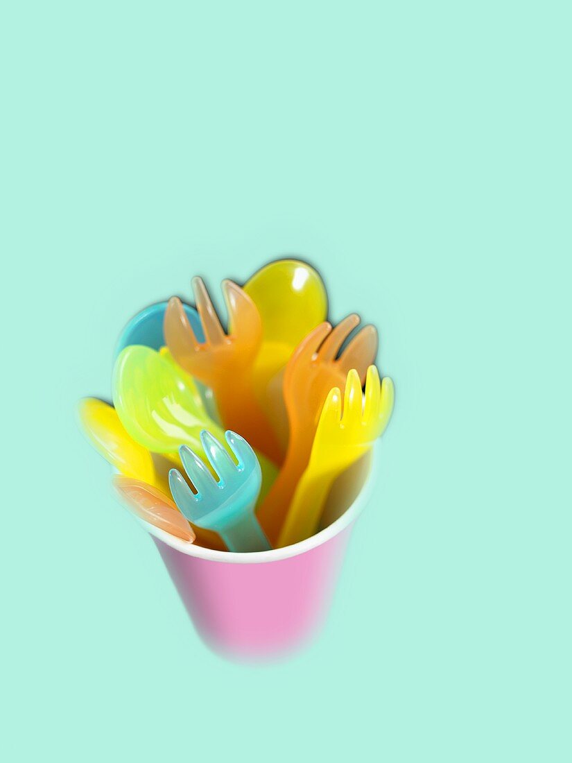 Plastic forks and spoons in a beaker