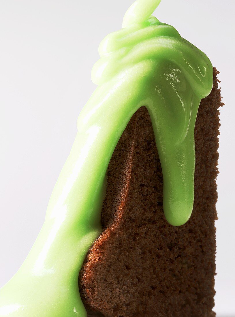 A piece of chocolate cake with mint sauce