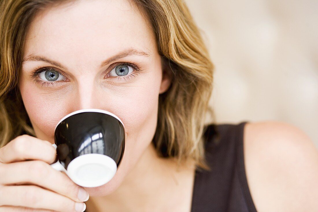Woman drinking an espresso