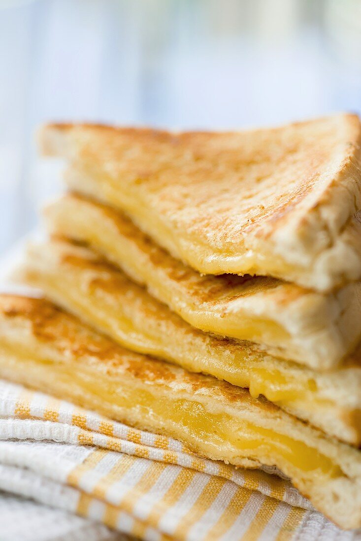 A pile of toasted cheese sandwiches