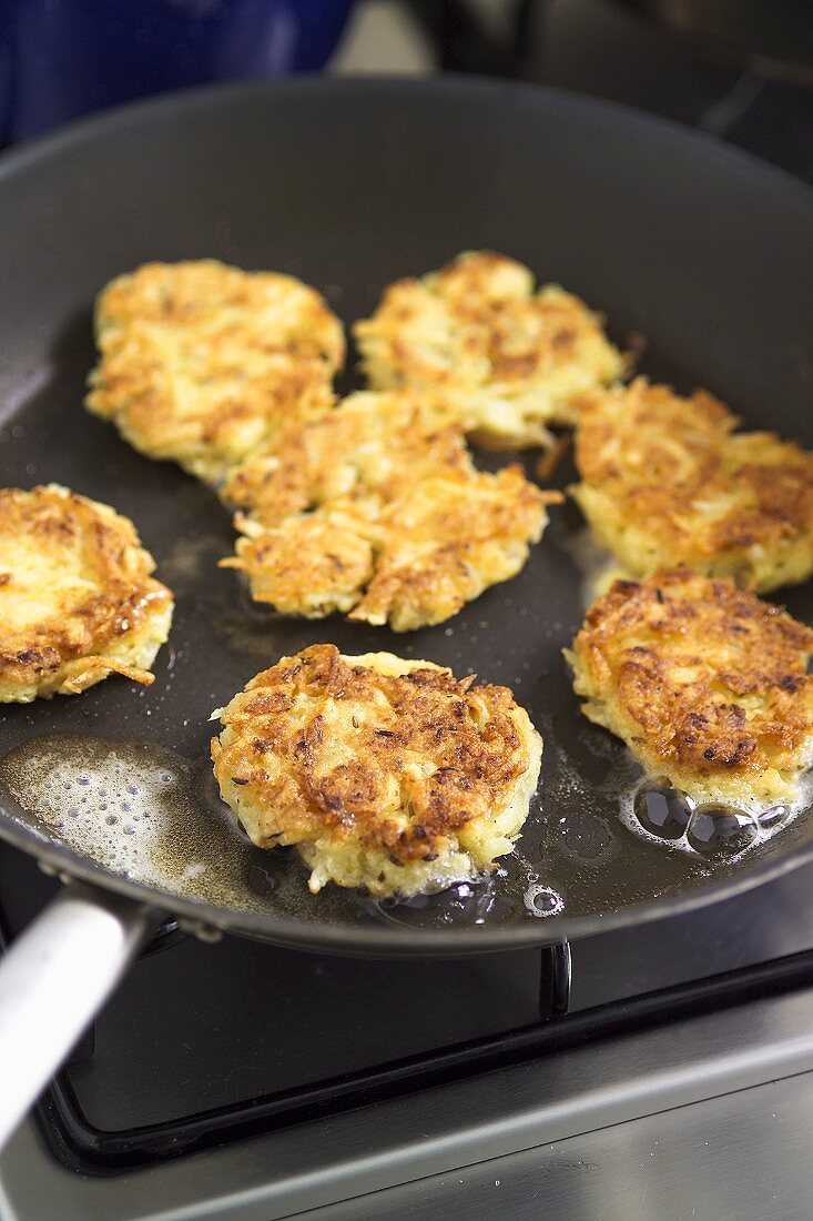 Frying latkas in frying pan