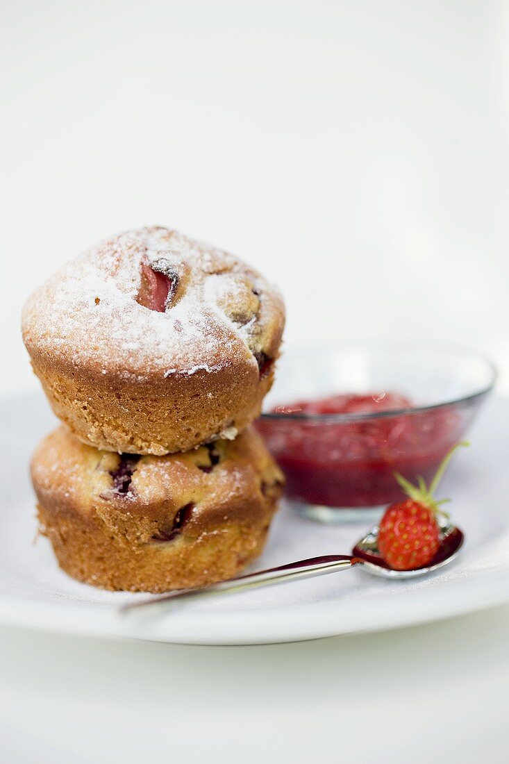 Two strawberry muffins with jam