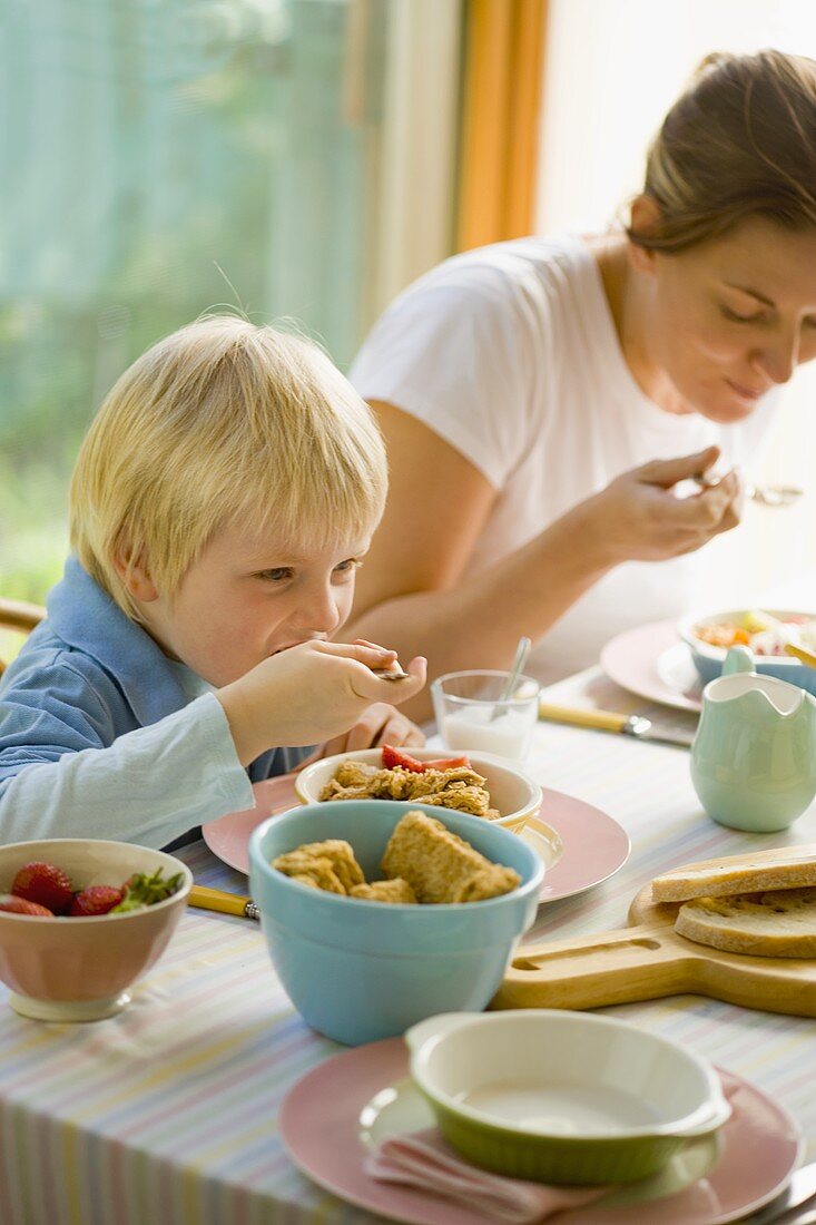 A woman and young boy having breakfast
