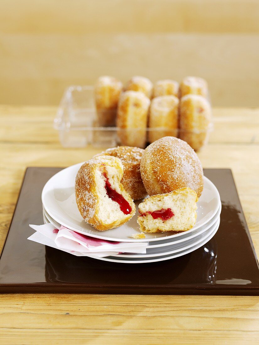 Several doughnuts on plate and in packaging