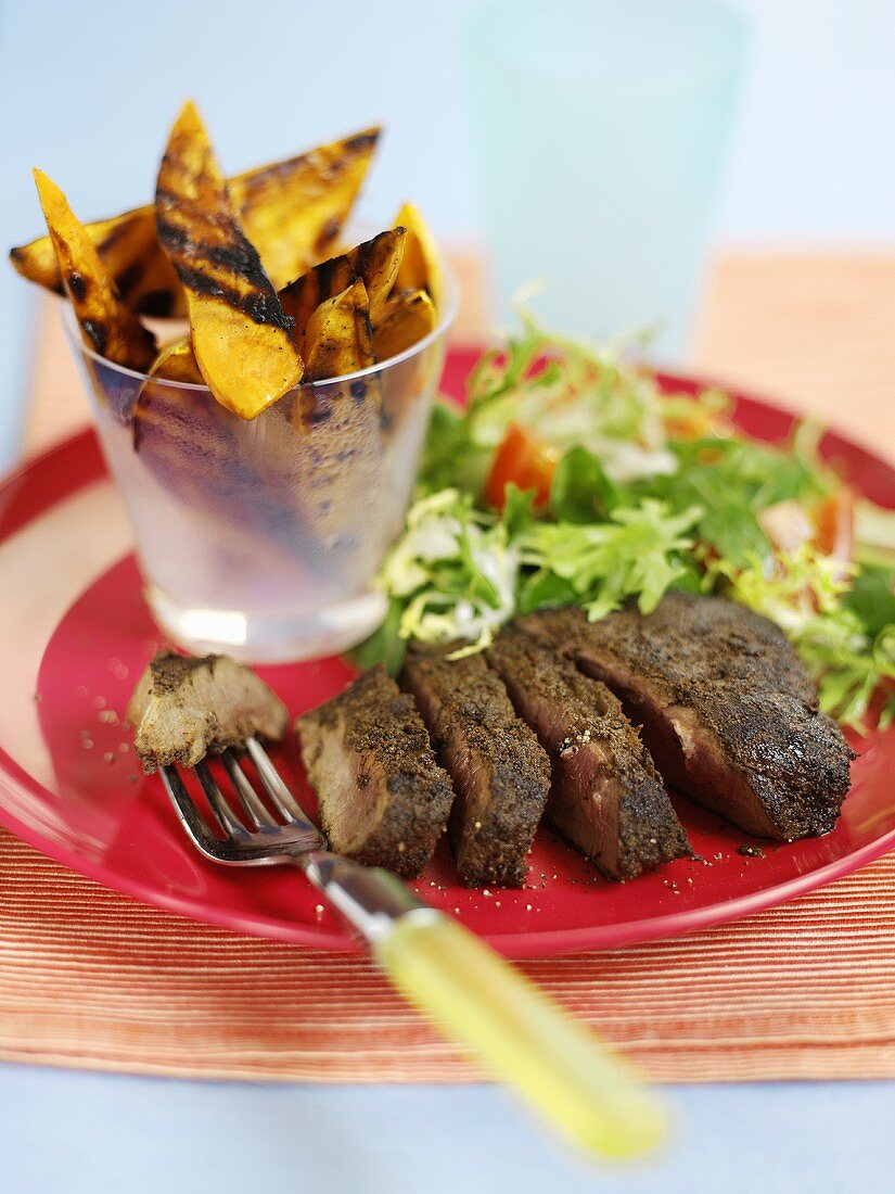 Java steak with grilled potatoes and salad